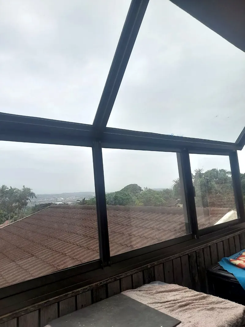Glazed patio enclosure framing with a view over the rooftops